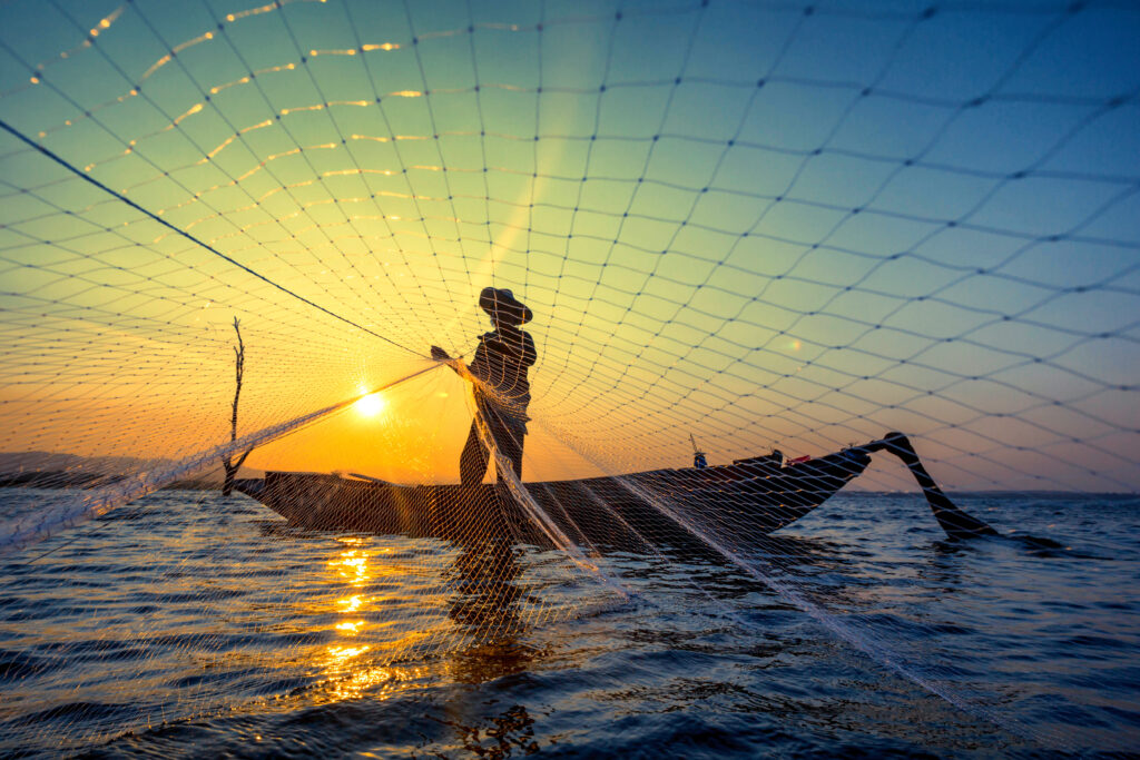 Fisherman at reservoir in the morning