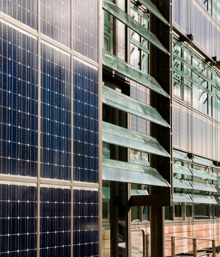 Building with glass panes and solar panels