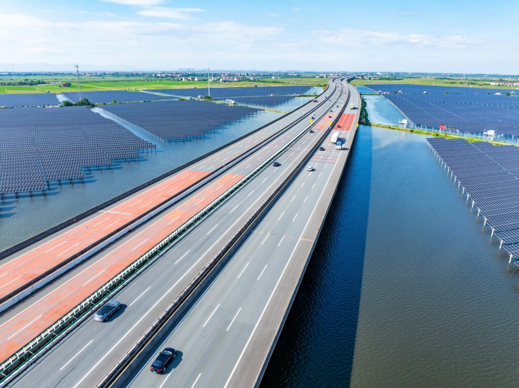 A highway built over a body of water with cars driving on it.